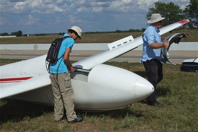 Image: Mike Weatherford and Jacob Fairbairn prepare the glider for dismantling.