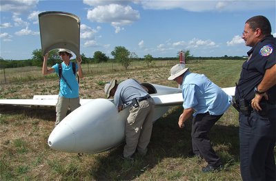 Image: A curious Chief Phoenix looks on as Jacob, Alan and Mike systematically take the glider apart.