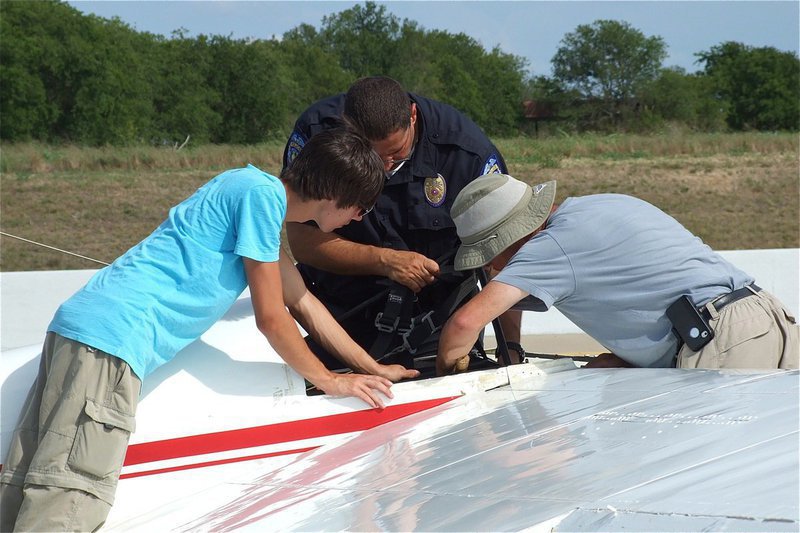 Image: Chief Phoenix lends a hand to Jacob and Alan in order to remove the second wing from the 1-26 glider.