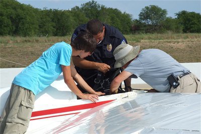Image: Chief Phoenix lends a hand to Jacob and Alan in order to remove the second wing from the 1-26 glider.