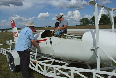 Image: Mike, Alan and Jacob secure the glider and the wings onto the trailer to make certain no parts fly off during the return trip to the airport.