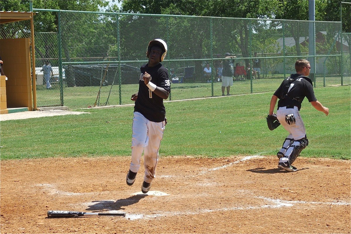 Image: Marvin Cox(1) crosses home plate for Italy.