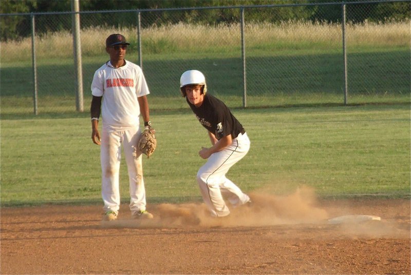 Image: Justin Wood steals second, and after a quick glance over his shoulder, he then steals third.