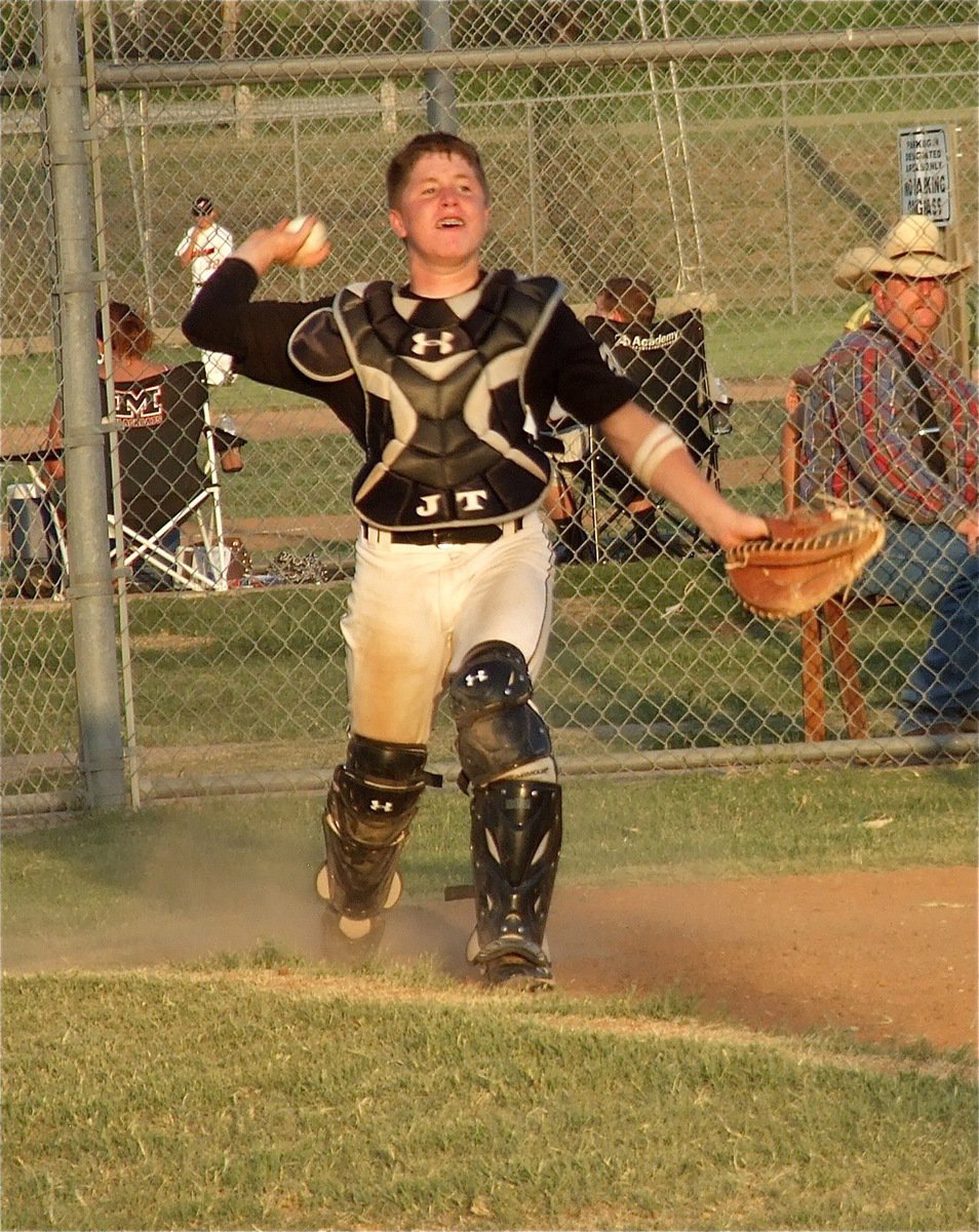 Image: Catcher John Escamilla rises to gun down a Mexia batter racing to first base.