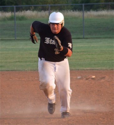 Image: Kevin Roldan(20) rushes back to first base after the Blackcats haul in a pop-fly.  