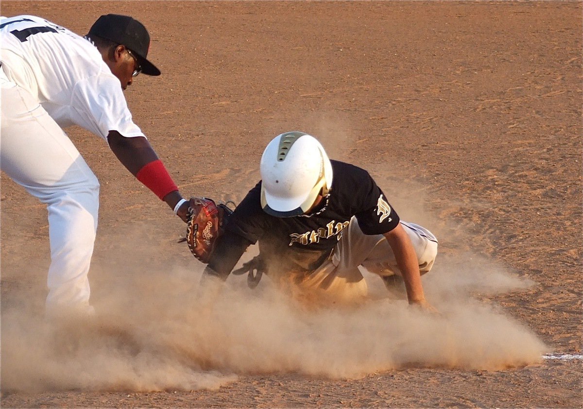 Image: Caden Jacinto slides safely back to first beating the tag from Mexia’s first baseman.