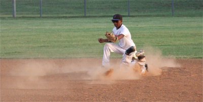 Image: Lost in the dust storm is Caden Jacinto sliding into second base.