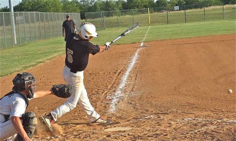 Image: Reid Jacinto sends a grounder toward the Blackcat defenses.