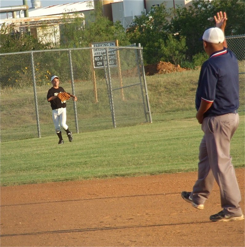 Image: Freshman Levi McBride makes a running catch for an out near the left field foul line.