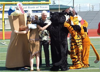 Image: Huddling with Dale Hansen are all the mascots representing their schools during the Dale Hansen Football Classic which will be held September 7-8.