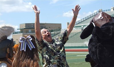 Image: Dale Hansen celebrates the mascot’s first team touchdown during filming.