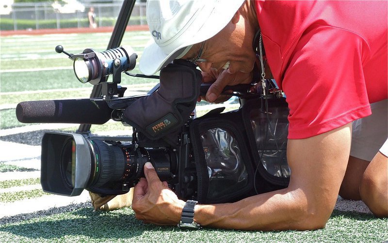 Image: WFAA Channel 8 Sports Videographer Arnold Payne hits the turf to get just the right angle.