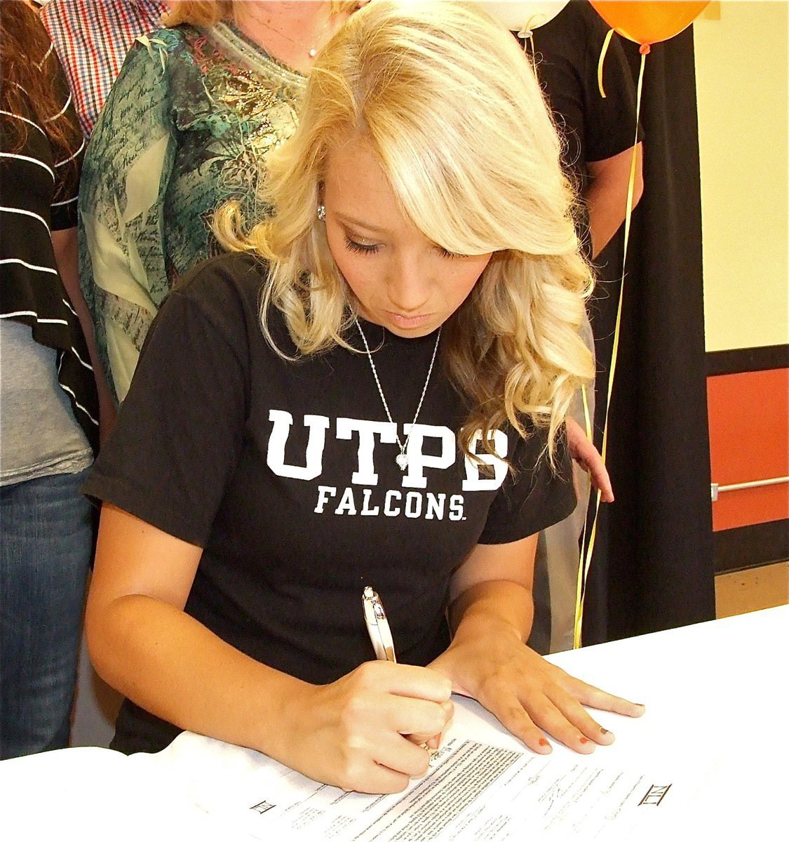 Image: It’s official! Italy’s Megan Richards signs her Letter of Intent to play softball for The University of Texas at the Permian Basin in Odessa while surrounded by proud family members and friends.