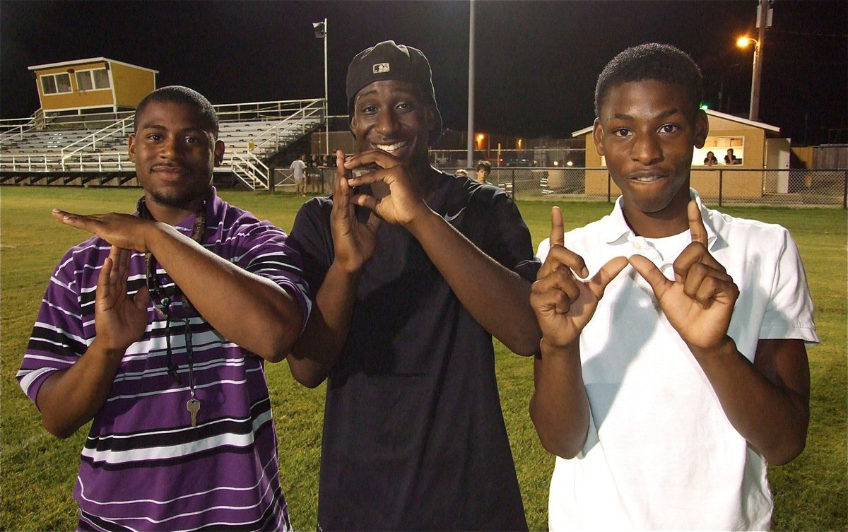 Image: T.P.W. — Gladiators Jalarnce Lewis, Marvin Cox and Eric Carson spell it out. The Athletic Department’s motto is, “Tough People Win.” At least they didn’t have to spell it in cursive!