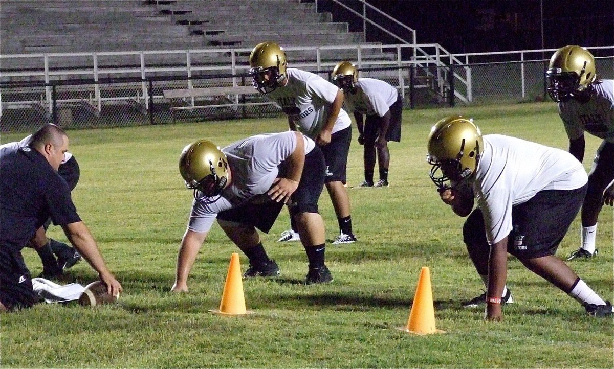 Image: King of the Squat: 525 pound squatter Hank Seabolt, a junior, prepares to anchor Italy’s defensive front at nose guard as Coach Brandon Duncan takes the defense thru its paces.