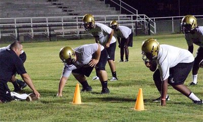 Image: King of the Squat: 525 pound squatter Hank Seabolt, a junior, prepares to anchor Italy’s defensive front at nose guard as Coach Brandon Duncan takes the defense thru its paces.