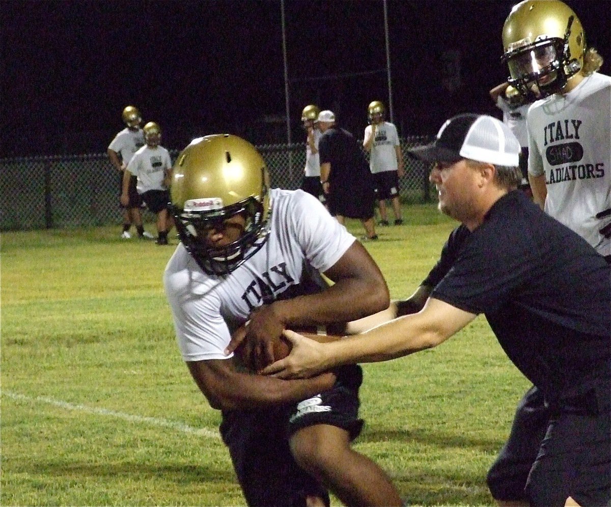 Image: Coach Josh Ward works with the running backs.