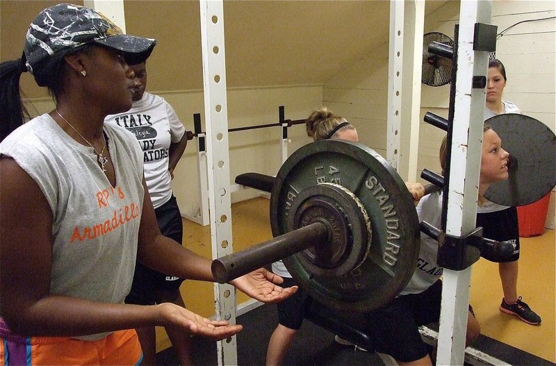 Image: Volleyball head coach Jessika Robinson helps to spot Bailey Eubank during her lift.