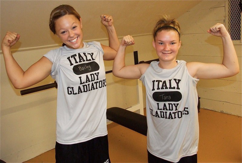 Image: Welcome to the gun show: Sophomores Bailey Eubank and Tara Wallis show their Lady Gladiator strength.