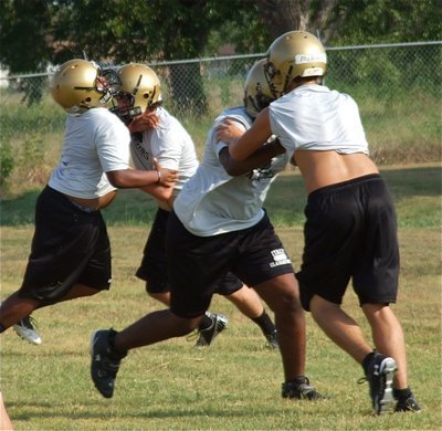 Image: Lineman go at it despite no pads on Wednesday.