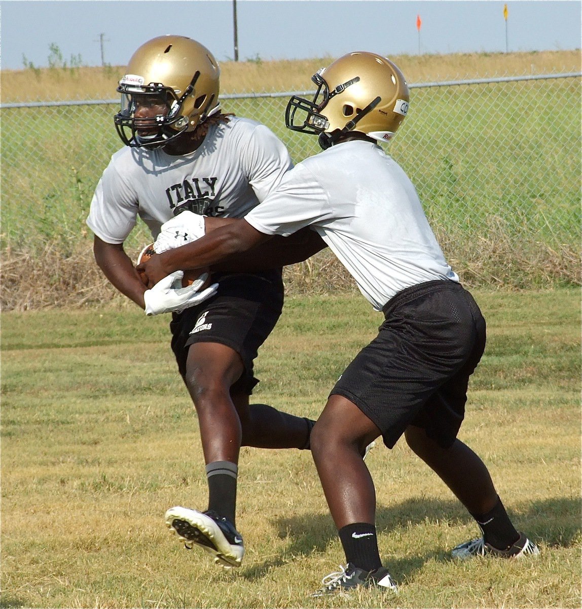 Image: Gladiator Marvin Cox hands off to teammate Ryheem Walker.