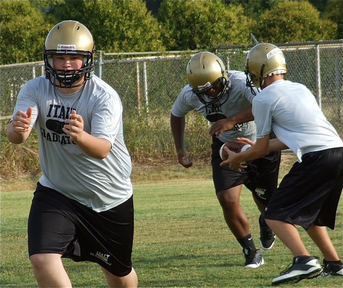 Image: John Byers leads the way for JV quarterback Ryan Connor who hands off to Billy Wilson.