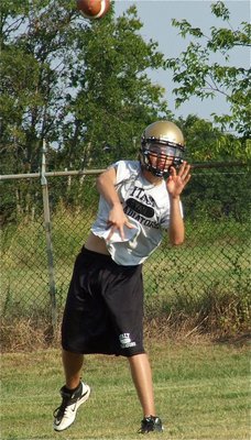 Image: JV quarterback Ryan Connor throws the ball to a receiver.