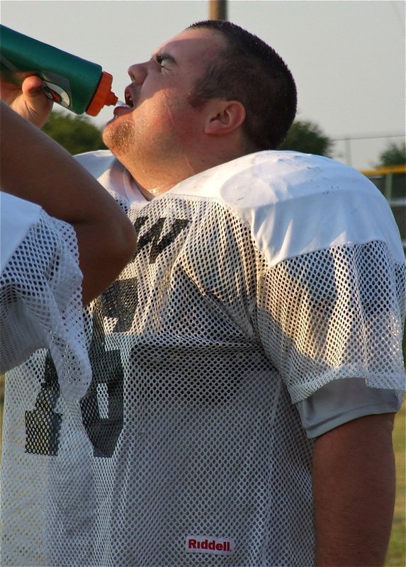 Image: Junior nose tackle Hank Seabolt(76) quenches his thirst for Gladiator football.