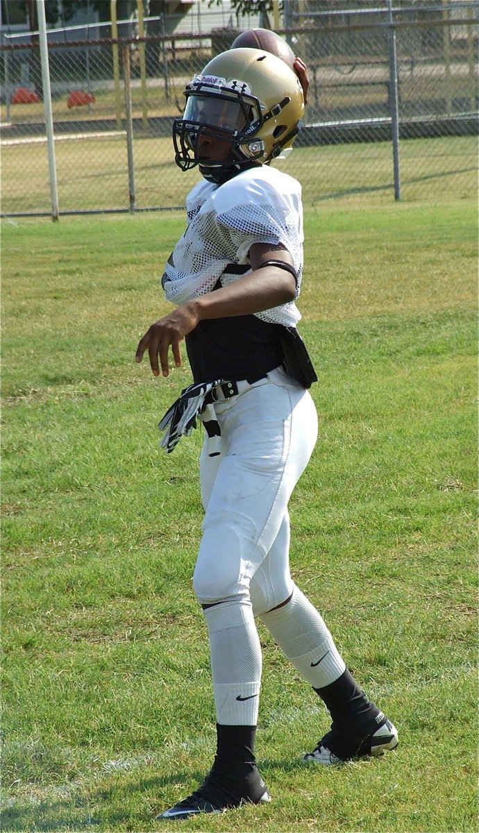 Image: Junior quarterback Eric Carson works on his pass release.