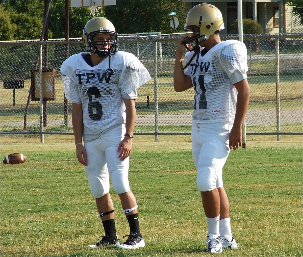 Image: Cousins Caden Jacinto(6) and Reid Jacinto(11) discuss their pass routes between snaps. Both players made sure-handed catches during team drills on Friday.