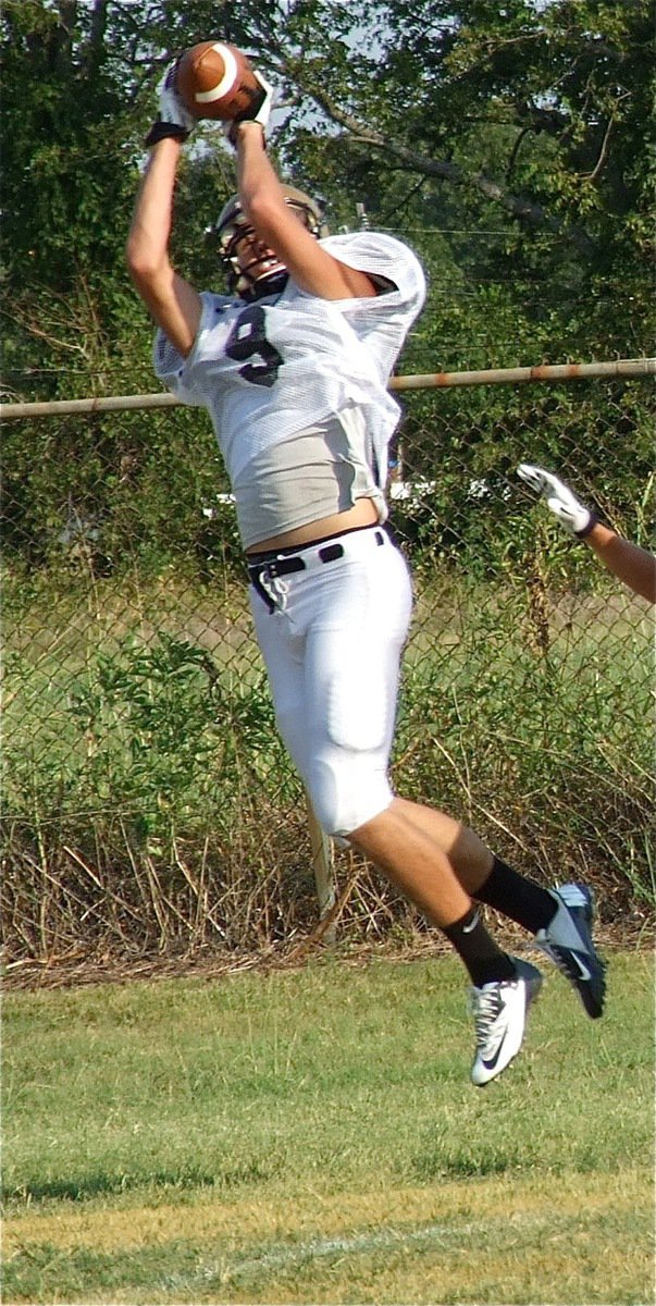 Image: Senior receiver Cole Hopkins(9) makes the grab beyond a defender.