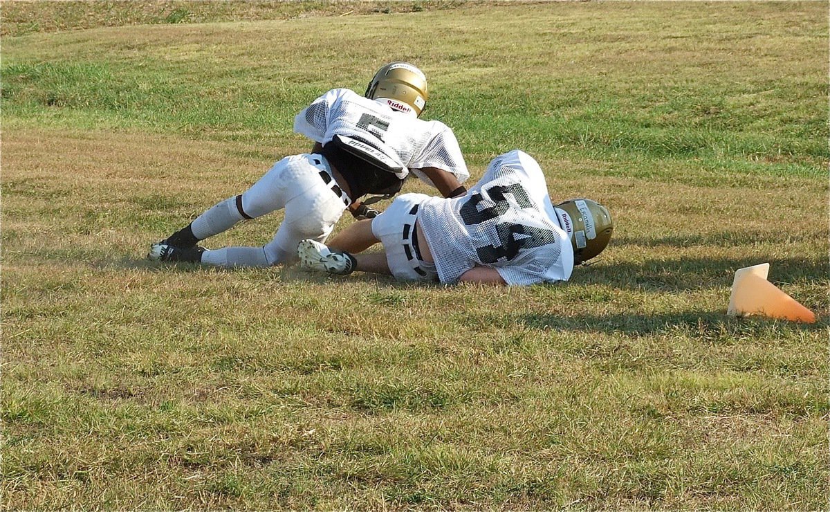 Image: Sophomore John Escamilla(54) recovers a fumble.