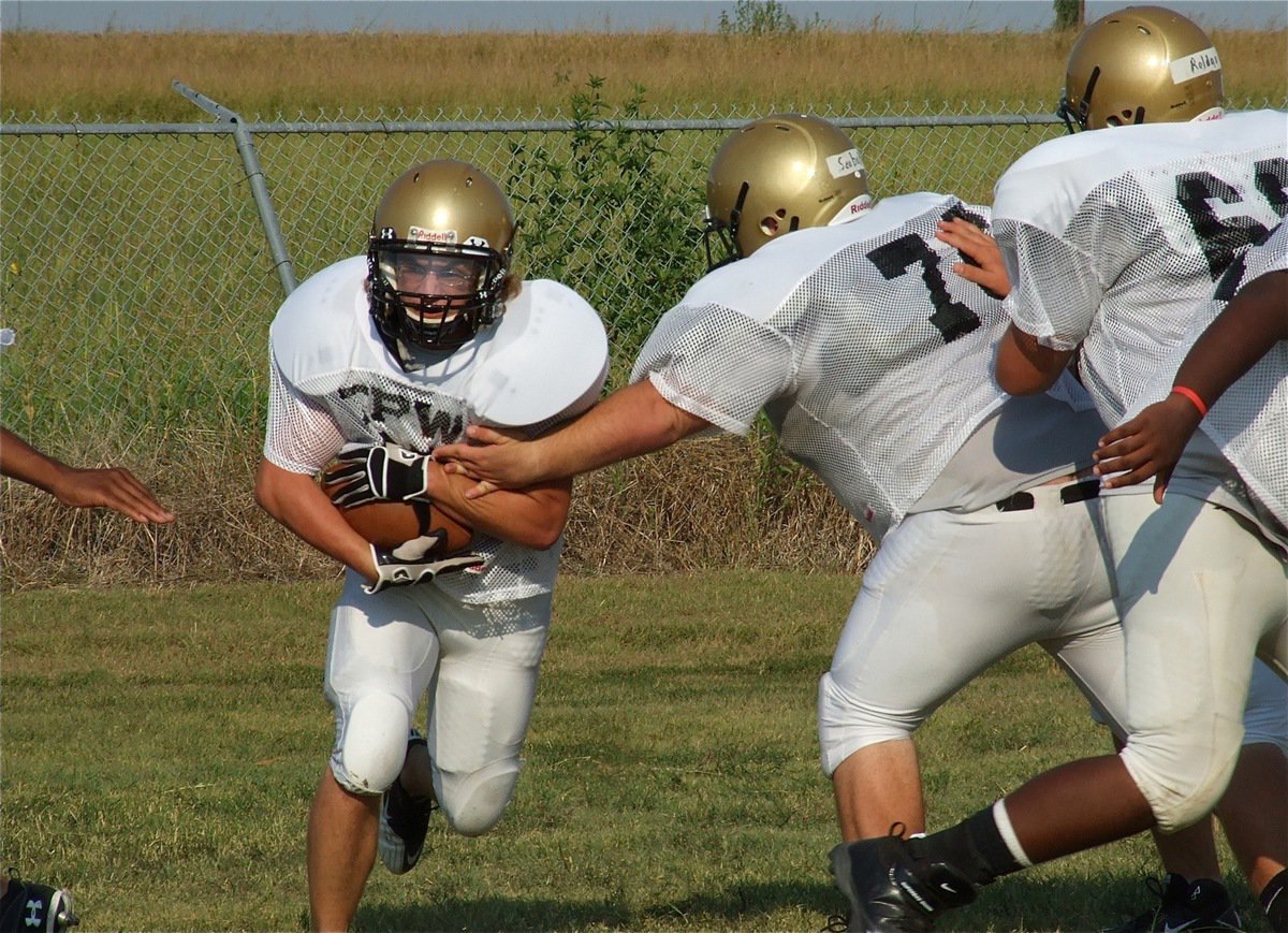 Image: Shad Newman protects the ball as he squeezes thru an opening.