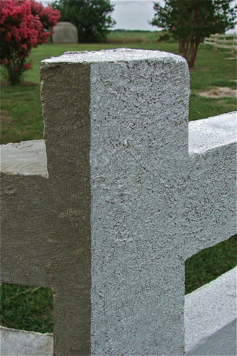 Image: A closer look of a corner post shows different textures that can be achieved while constructing the fence. Plus, a side-by-side comparison of shows the original sandy-white colorant added to the concrete mix contrasted with a painted coat of white-wash on the right.