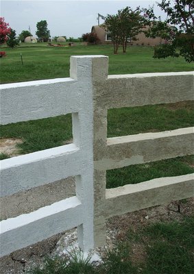 Image: This middle section post is divided to show a couple of different fence coloring options. The left half has a lime ingredient included in the mixture that was used to white wash the fence. The right section was left unpainted to reveal the sandy-white colorant used in the original mix. In actuallity, the fence will never require painting and could remain a sandy-white color.