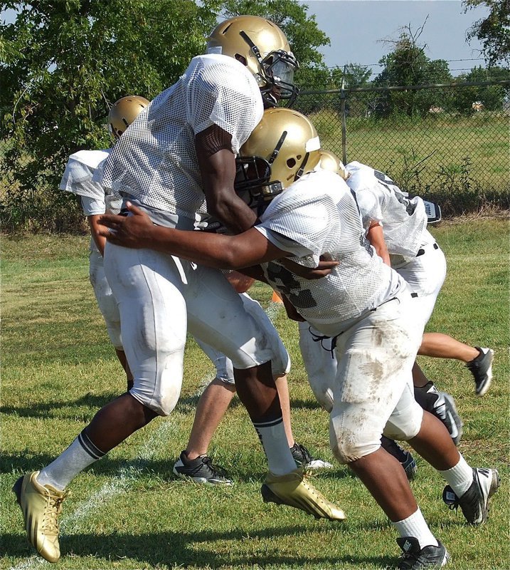 Image: Ryheem Walker and Tre Jackson demonstrate proper force and form in a tackling drill.