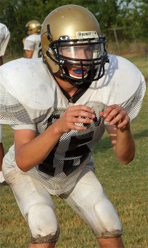 Image: JV quarterback Ryan Connor (15) calls for the snap.