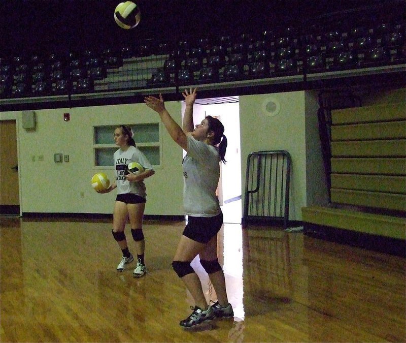 Image: Bailey DeBorde serves during the JV practice.