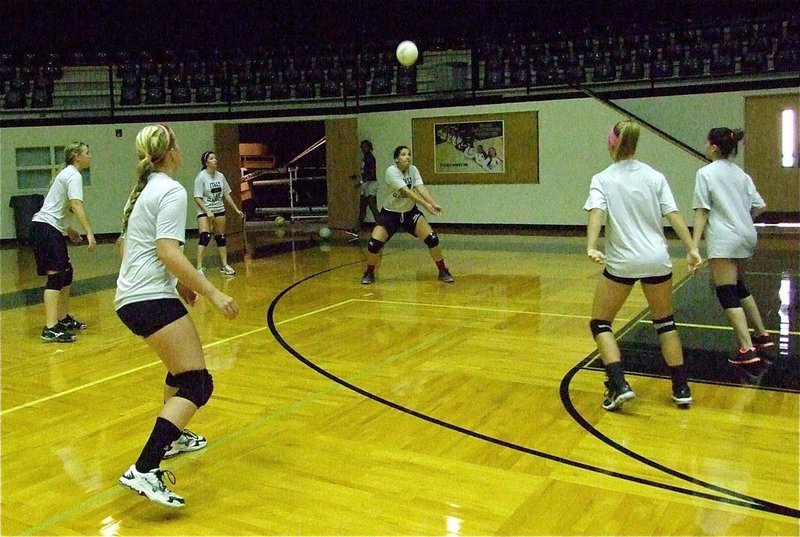 Image: Alyssa Richards bumps the serve into play.