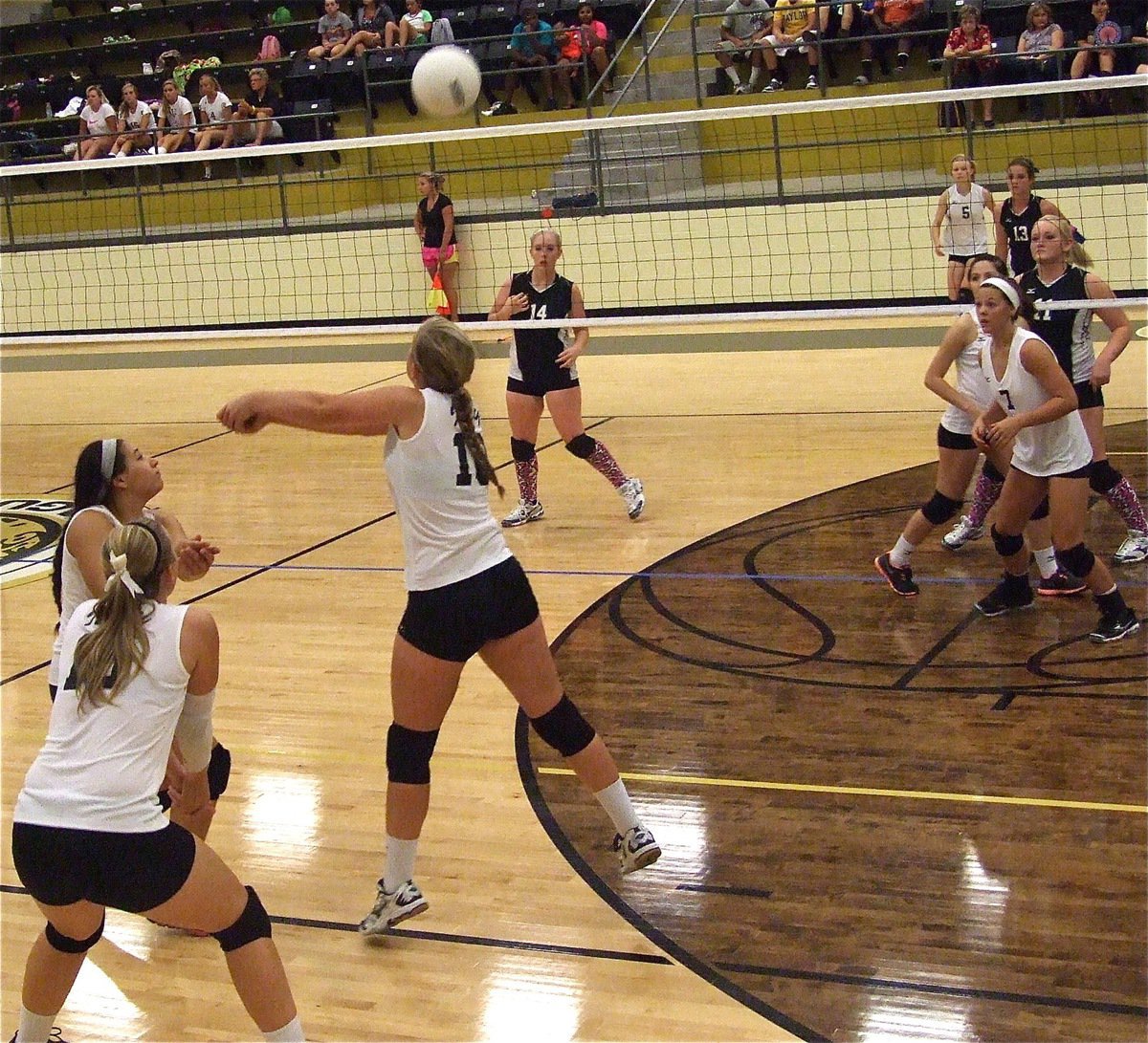 Image: Alyssa Richards(13), Jaclynn Lewis(15) and Madison Washington(10) attack the serve from Hubbard.