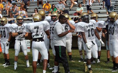 Image: Injured senior Gladiator Adrian “BoBo” Reed gets his teammates fired up before they take Willis Field against Valley Mills.