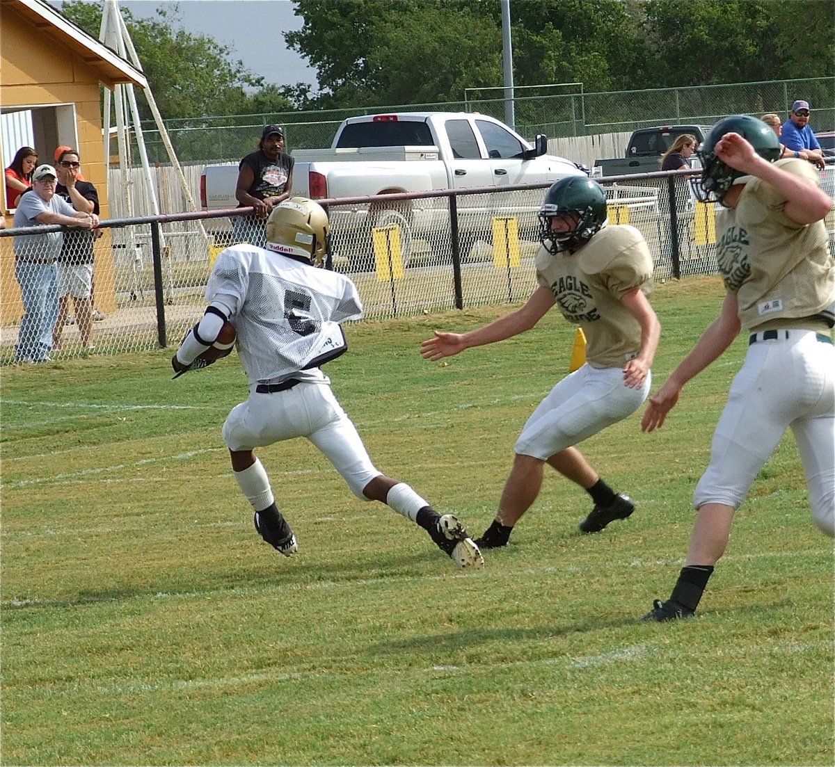 Image: Quarterback Eric Carson(5) leaves Eagles in his wake as he rolls toward the endzone.