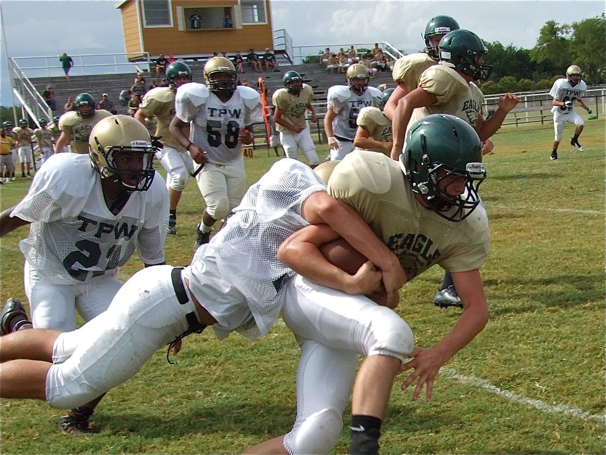 Image: Cody Medrano(75) makes the tackle before the Eagles can turn upfield.