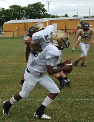 Image: Center Zain Byers(50) keeps Eric Carson(5) safe and sound while maneuvering in the pocket.