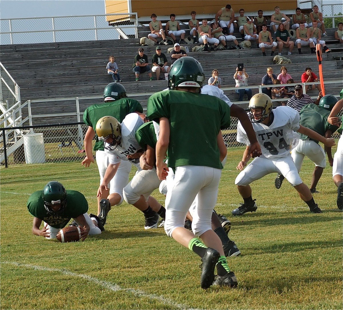 Image: Italy’s John Byers(56) and Hunter Merriman(84) chase after a fumble in the Eagle backfield.