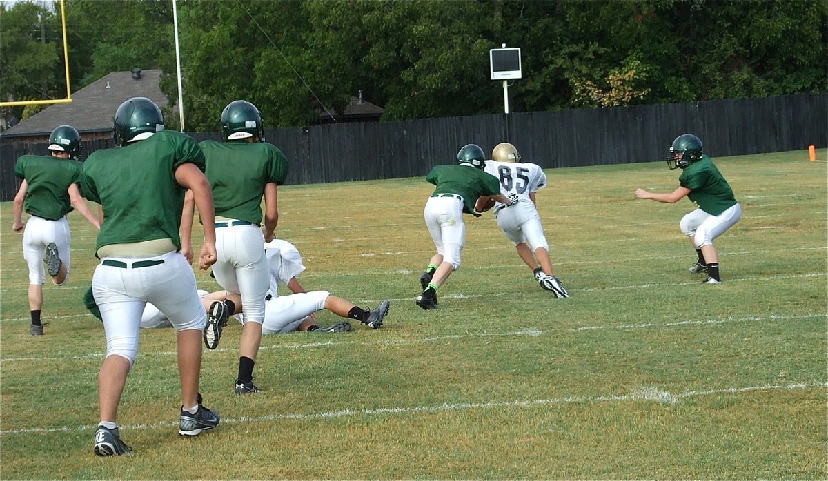 Image: Levi McBride(85) hauls in the pass from his quarterback Ryan Connor and heads upfield for the first big play of the JV scrimmage against Valley Mills.