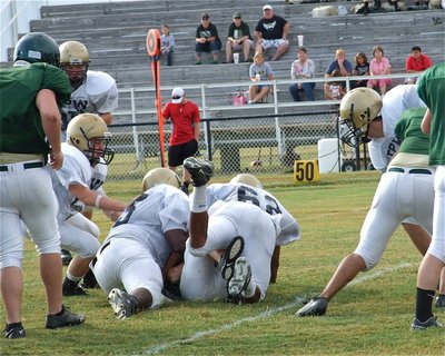 Image: Italy’s JV noseguard Justin Robinson(65) and tackle John “Squirt” Hughes(62) knocks a few feathers off an Eagle running back.