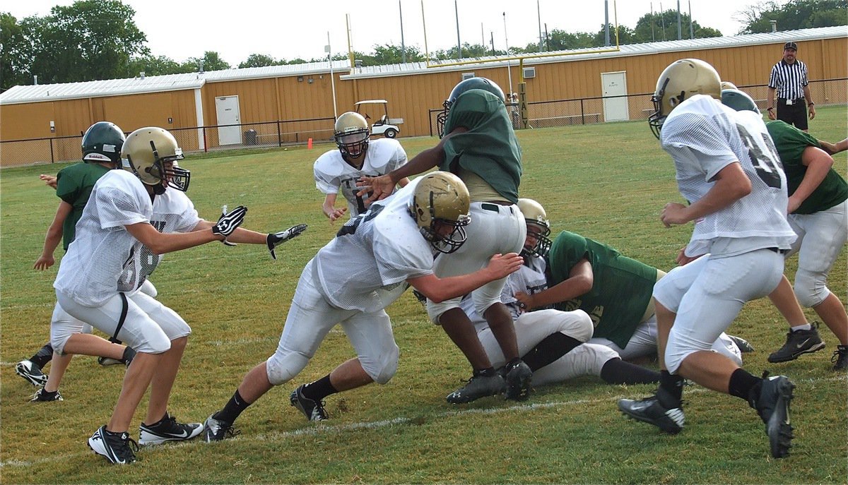 Image: Italy’s linebacker Kyle “Catfish” Fortenberry(66) reels in an Eagle back for breakfast during Saturday morning’s scrimmage.