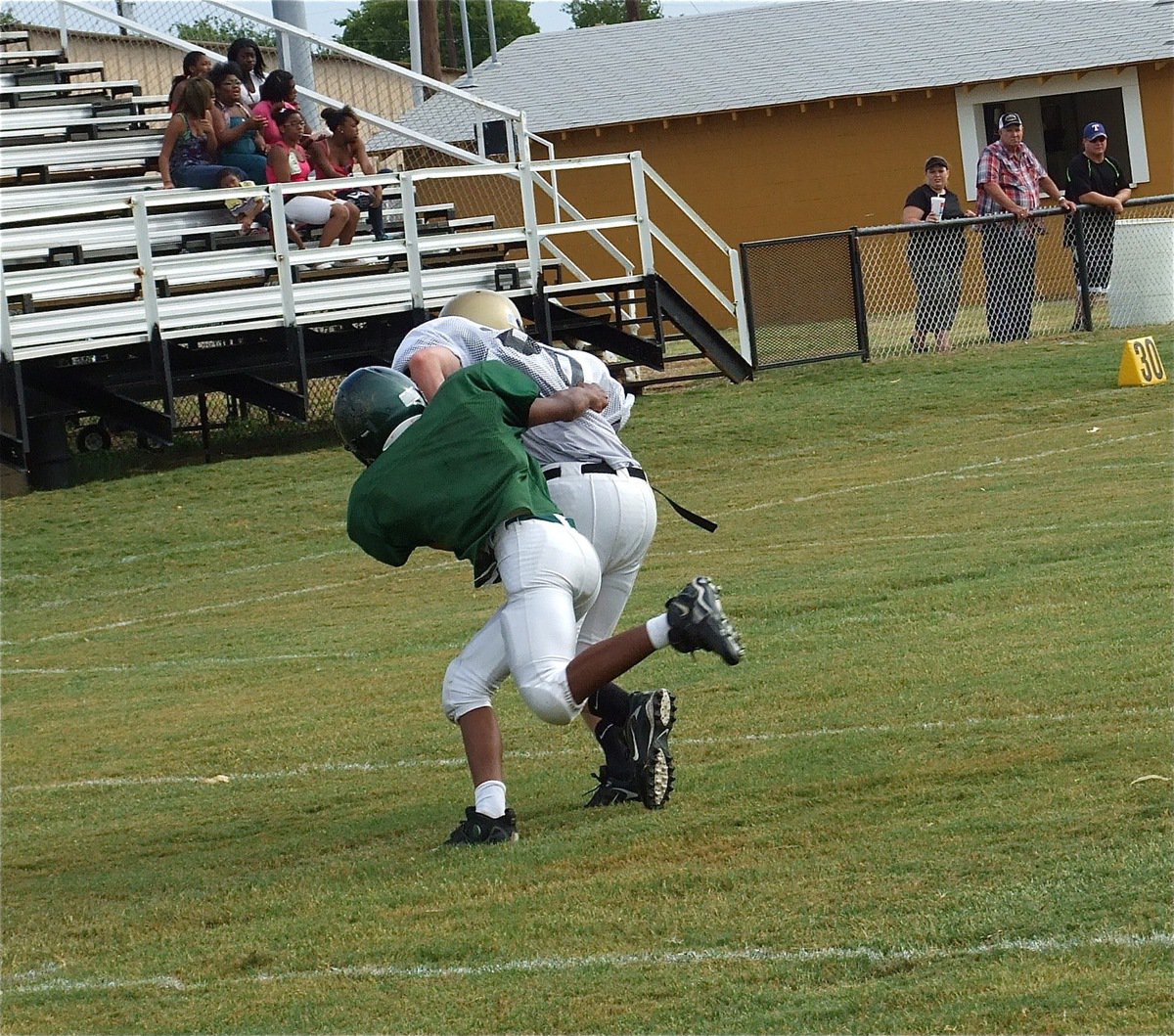 Image: Italy’s Cody Boyd(30) hauls in a pass then tries to escape the Eagle defense for more yards.