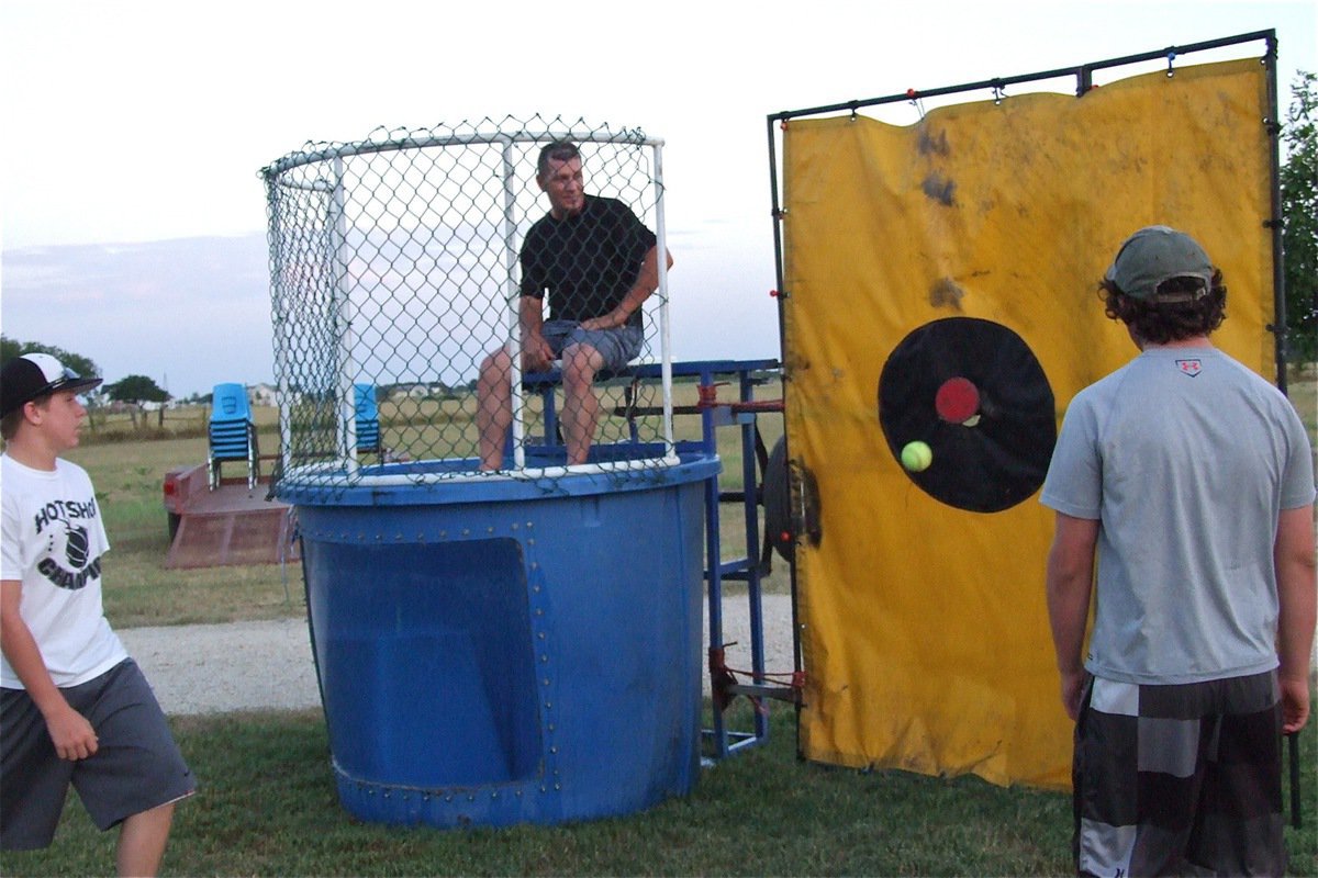 Image: Italy High School Alumni Lee Hamilton volunteers to be the dunkee to start off the Back to school Bash held at the home of IHS School Board member Russ Lewis and his wife Kelly.